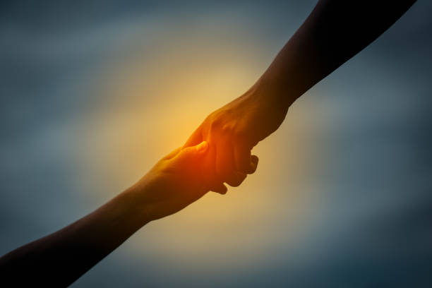 istock Hand to hand holding connect relationship 990454438