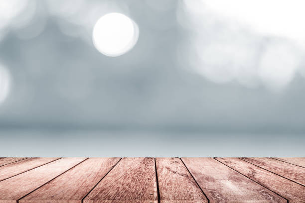 istock empty wooden on white blurred nature backdrop. Wood table top. can used for display or montage your products 990454846