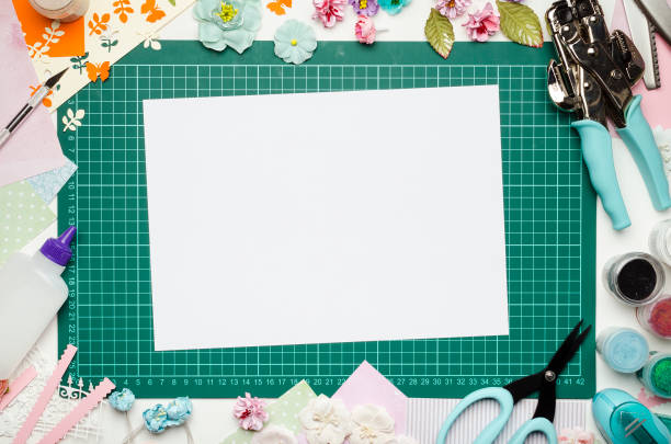 istock The cutting mat is surrounded by paper flowers, paper, tools and scrapbooking materials 990458074