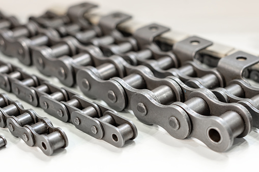 Mental chain for mechanical chain transfer. Photo with shallow depth of field. Abstract industrial background.