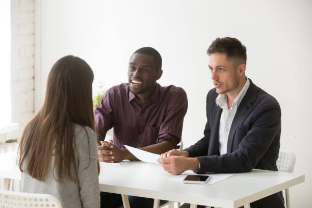 istock Friendly multiethnic hr team considering female candidate position 990458750