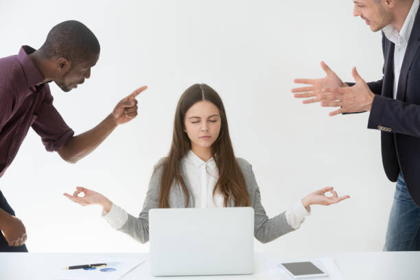 istock Calm female employee practicing yoga at workplace 990458790