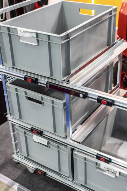 istock Gray plastic boxes on the shelving of an industrial warehouse 990461962