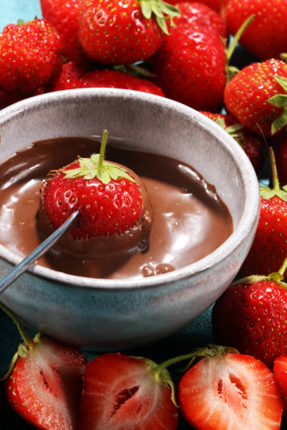 istock Fondue with Melting chocolate or melted chocolate and strawberry. 990462490