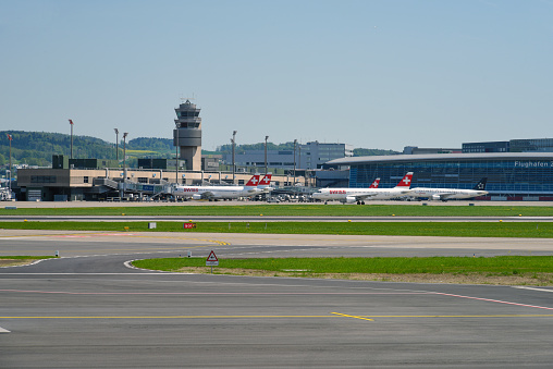 Zurich Airport ZRH with some passenger aircrafts waiting on gate. The Image was captured during spring season.
