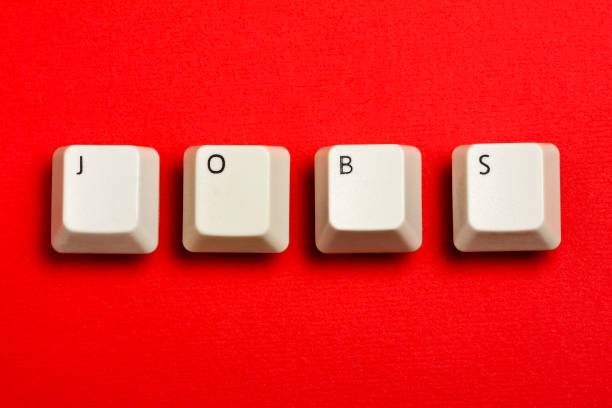 istock jobs text formed with real white keyboard keys on red 990465636