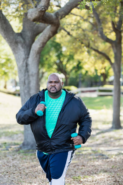istock Mature African-American man exercising, jogging in park 990466344