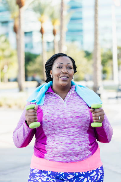istock African-American woman exercising with hand weights 990466584