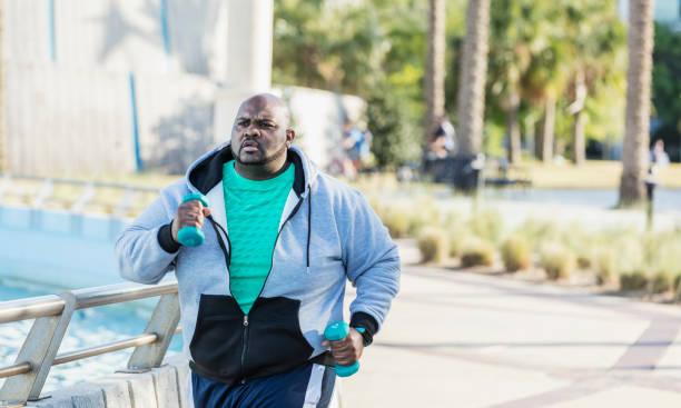 afrikanisch-amerikanischer mann joggen oder powerwalking - people effort waist up african ethnicity stock-fotos und bilder