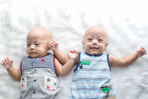 istock Newborn twins sleeping.Newborn Babies Twins Sleep in Bed. 990467106