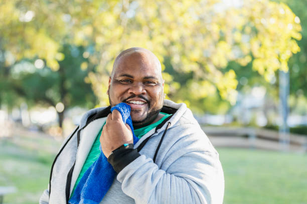 istock Man wiping face with towel after exercising 990469272