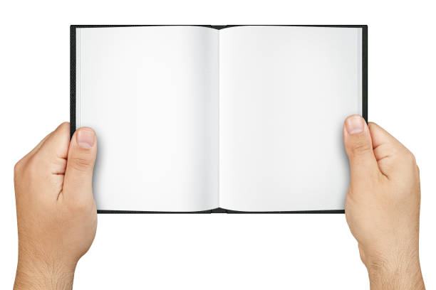 istock Top view of hands holding open book with blank pages isolated 990473430