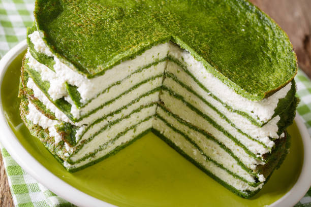 istock Delicious spinach crepe cake with cheese cream close-up. horizontal 990474794