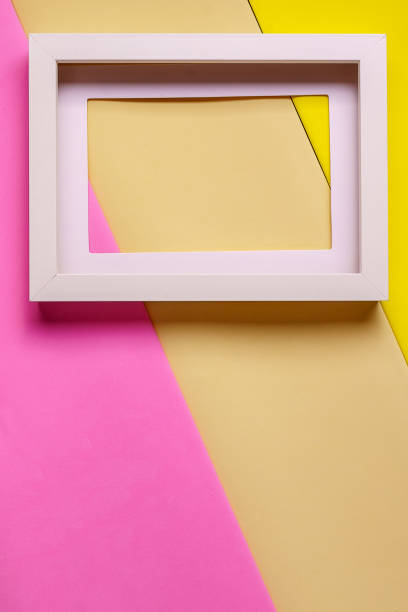 istock Abstract minimalism colofrul paper background with empty picture frame. 990479208