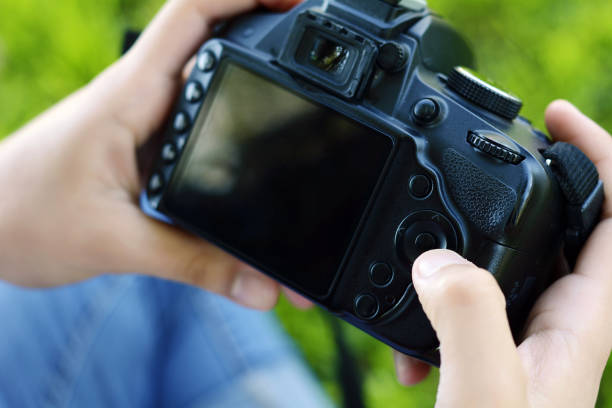 istock Professional woman looking at photo camera 990480826