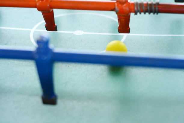 istock Soccer table game, blue foosball player. 990480928