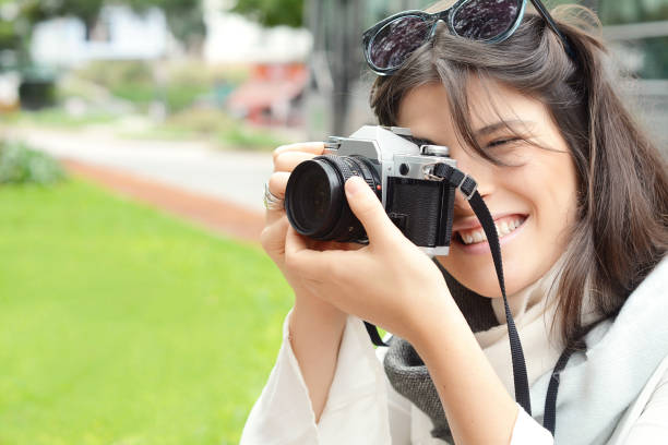 istock woman with old vintage camera 990481046