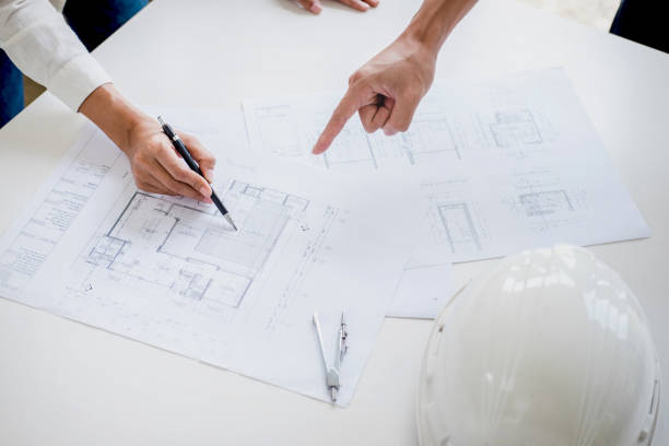 istock Architect or Engineer meeting working with partner on blueprint for architectural project in progress, construction and structure concept 990487616
