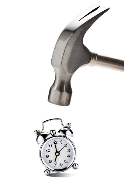 istock Big Hammer Hitting Vintage Clock Alarm 990491758
