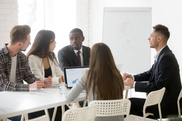 istock Focused colleagues cooperating talking about strategies and plans 990492674