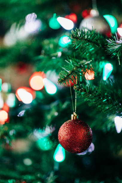 istock Close look at Christmas baubles hanging from a Christmas tree. 990505848
