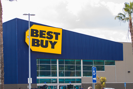 Burbank CA USA: November 27 2017: Best Buy is an American multi-national consumer electronics corporation. Best Buy store facade with huge sign in downtown Burbank city with people walking around entrance during the holidays.