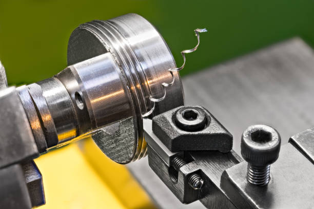 threading by a steel tool bit on a lathe.  idea of machining and metalwork - bolt machine part screw threaded imagens e fotografias de stock