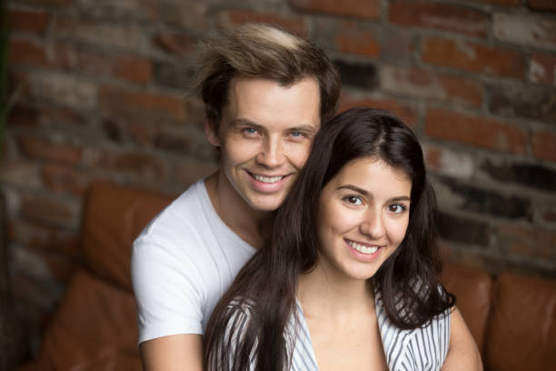 istock Portrait of young spouses hugging posing to camera 990534082
