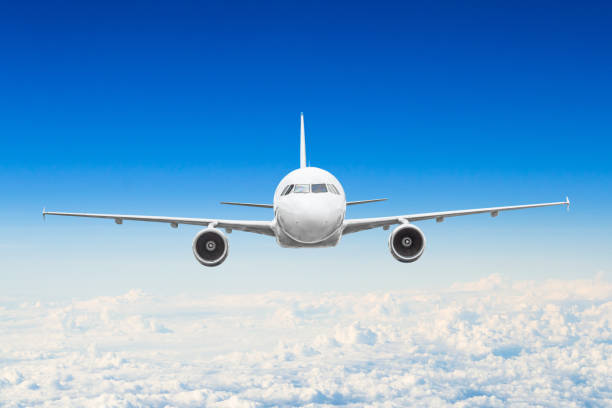 istock Airplane in the sky above the clouds flight journey sun height 990534352