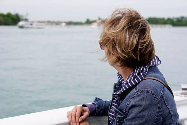 istock Female tourist on a deck of a cruise ship 990536986
