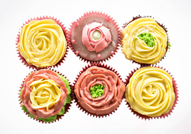 istock Capcake with yellow and pink cream on a white background. Isolate. 990537774