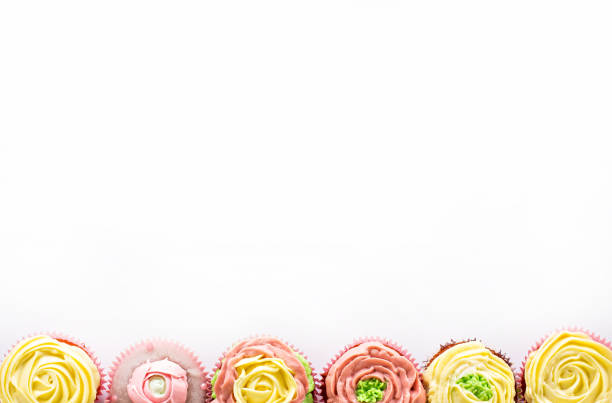 istock Capcake with yellow and pink cream on a white background. Isolate. 990537864