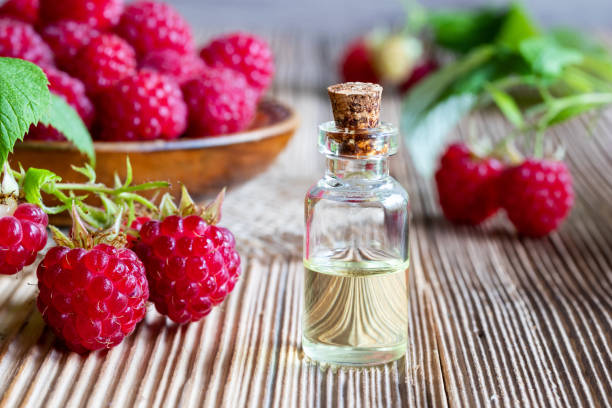 istock A bottle of raspberry seed oil with fresh raspberries 990541476