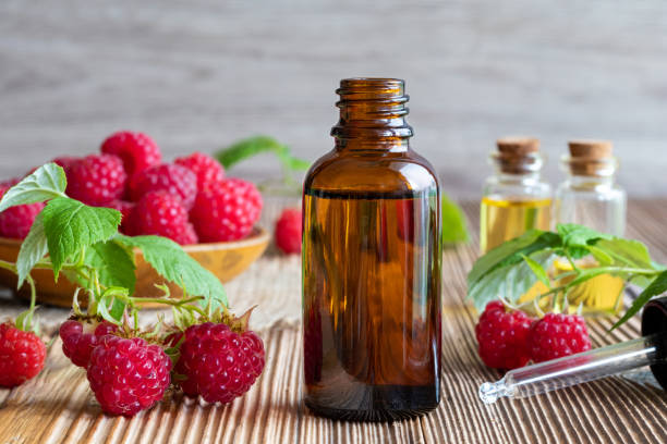 istock A bottle of raspberry seed oil with fresh raspberries 990541498