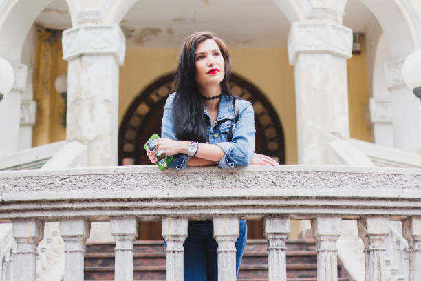 Victorian woman outside a creepy mansion