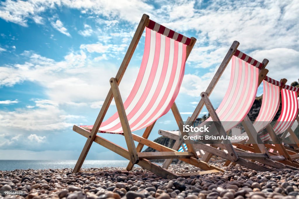 Deck chairs on the beach at the seaside summer vacation Deck chairs on the beach at the seaside on summer vacation UK Stock Photo