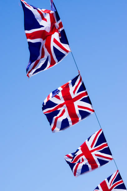 istock Union jacks flying from a phone cable strung across a street 990570110