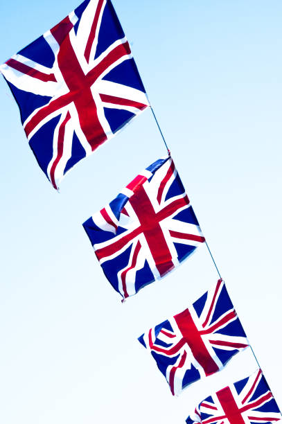 istock Union jacks flying from a phone cable strung across a street 990570544
