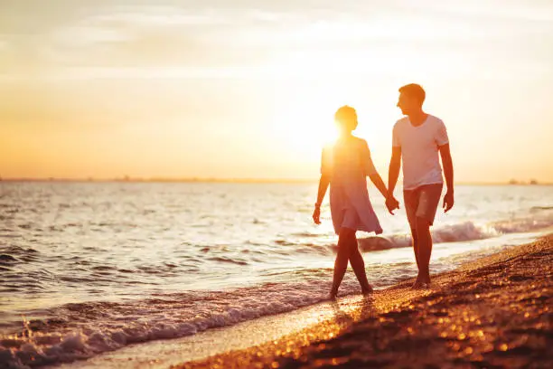 Photo of Young happy couple on seashore.