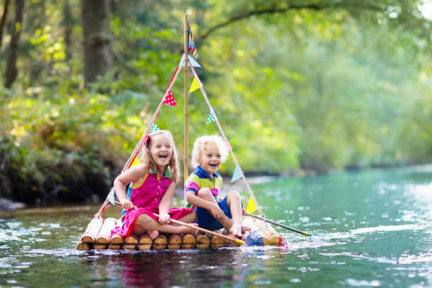 istock Kids on wooden raft 990584504