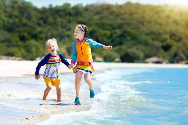 dzieci na tropikalnej plaży. dzieci bawiące się na morzu. - 16199 zdjęcia i obrazy z banku zdjęć