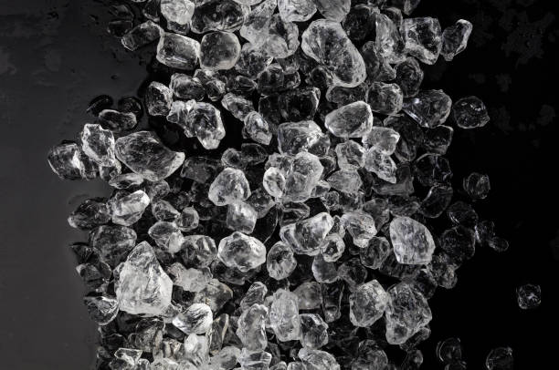 istock Pieces of crushed ice on black background 990586488