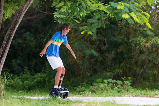 istock Child on hover board. Kids riding scooter 990588834