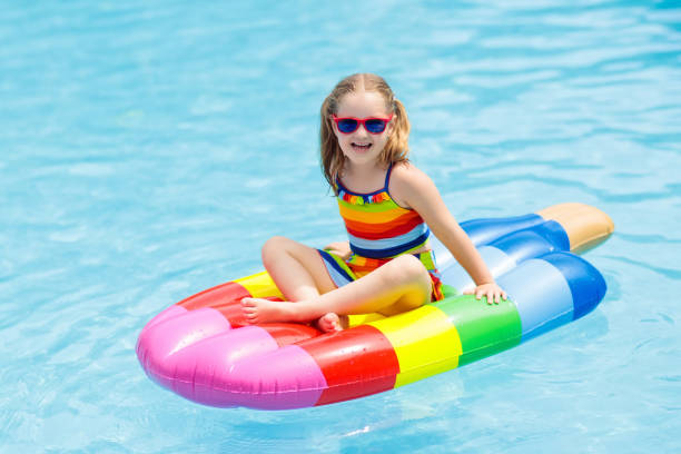 istock Child on inflatable float in swimming pool. 990589674