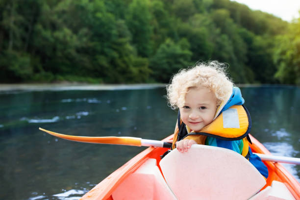 istock Child on kayak. Kids on canoe. Summer camping. 990589992
