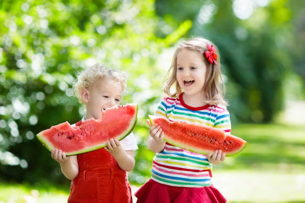 istock Kids eating watermelon in the garden 990595100