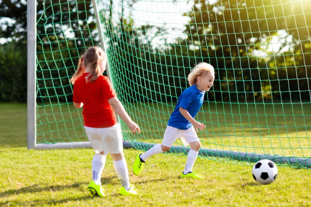 i bambini giocano a football. bambino al campo da calcio. - 16243 foto e immagini stock