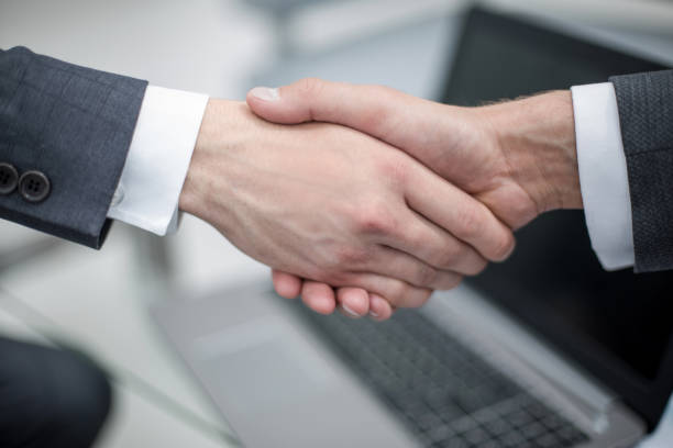 istock close up. handshake business people 990598264
