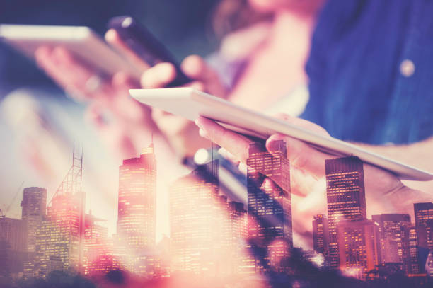 istock digital tablet in hand with city skyline. 990606510