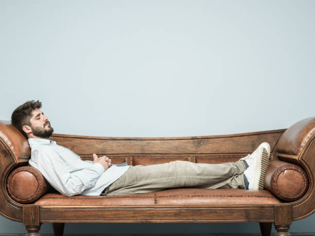 istock Adult Man Lying Down On Psychiatrist Couch 990619442